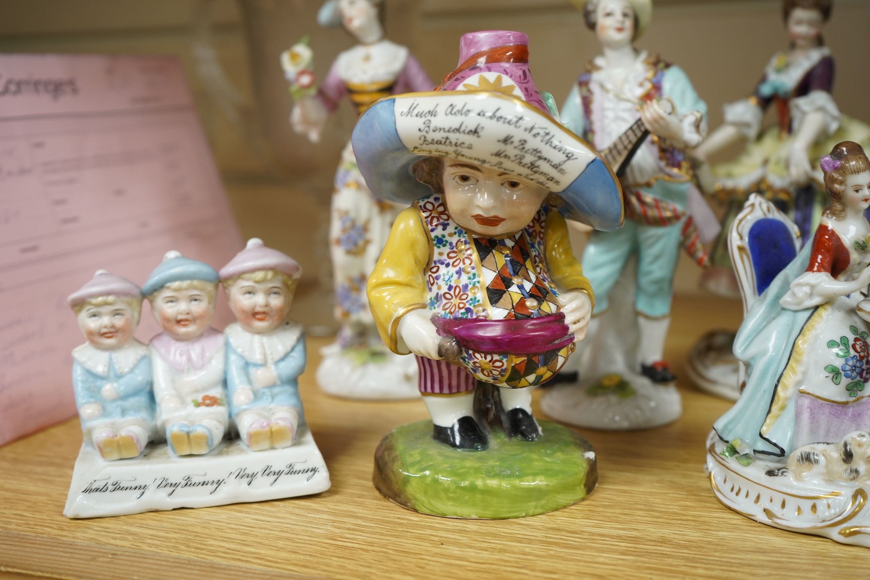 A French porcelain figure of a Mansion House dwarf, various German porcelain figures, an engraved glass and bowl. Glass 19cm